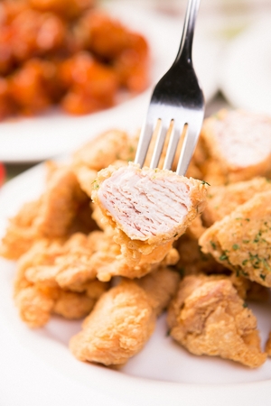 fried chicken with parsley on forkの写真素材