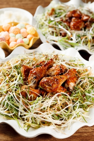 grilled chicken with spring onions and sauceの写真素材