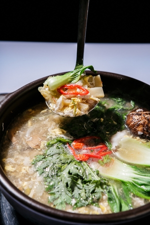 egg soup with vegetables in Ttukbaegi, earthen potの写真素材