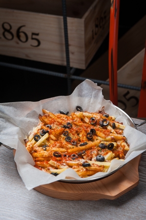 french fries pizza with olives on grill pan