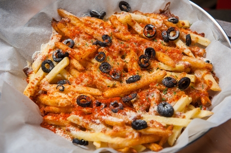 french fries pizza with olives on grill pan