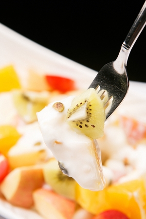 fruits salad made of kiwi, orange and cherry tomatoの写真素材