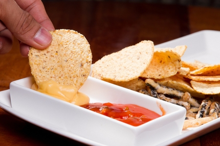 nachos dipped in cheese sauce