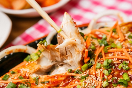 grilled mackerel with vegetables on chopsticksの写真素材