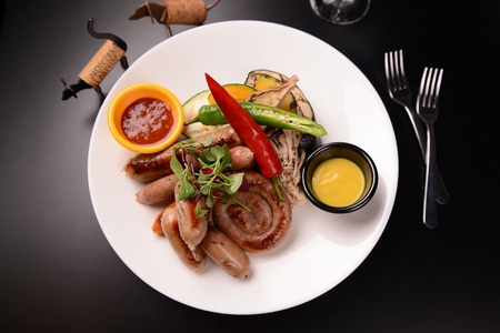 grilled sausage with chili and grilled vegetablesの写真素材