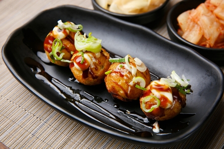 Japanese octopus ball, Takoyaki with spring onion and barbecue sauceの写真素材