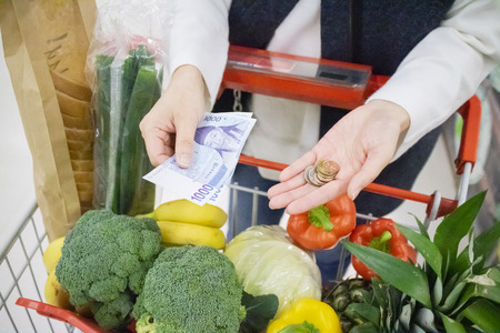 Vegetables and fruits shopping cart at grocery store.