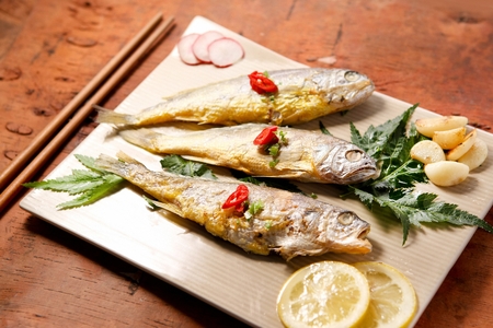 grilled yellow corvina with chili on plateの写真素材