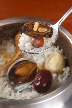 Hot pot rice with various ingredients such as abalones, jujube and chestnutの写真素材