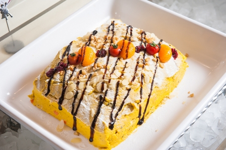 Sweet pumpkin salad with almond slices and sauce, on plateの写真素材