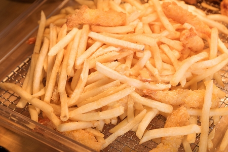 Thinly sliced french fries on plastic plate