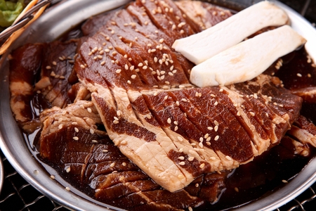 Raw marinated pork spareribs on stainless plateの写真素材