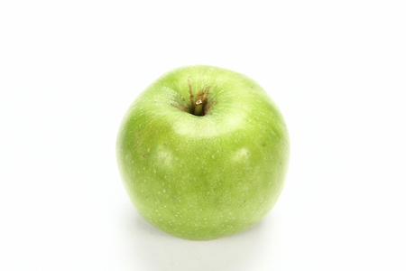 single green apple, white backgroundの写真素材