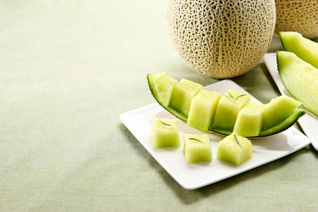 Sliced melon on white plateの写真素材
