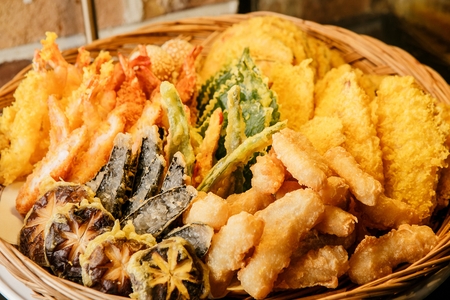 Assorted korean pancakes such as mushroom pancakes, perilla pancakes and eggplant pancakes in basketの写真素材