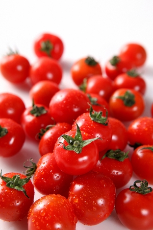 Cherry tomatoes in white backgroudnの写真素材