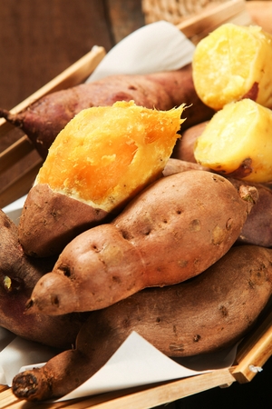 sweet potatoes on woven basketの写真素材
