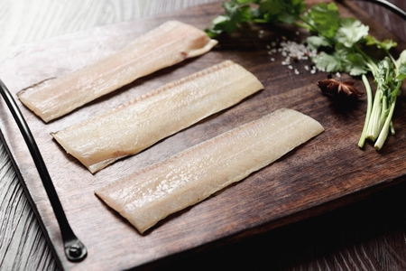 dried fish on wooden plate