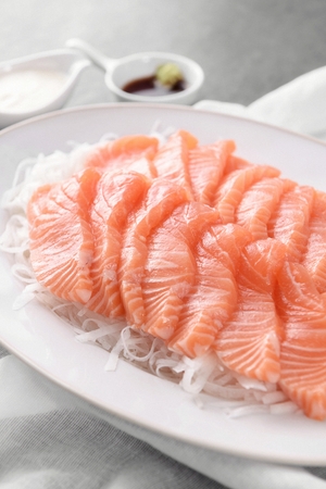 raw salmon on round plate, with steamed seaweed noodlesの写真素材