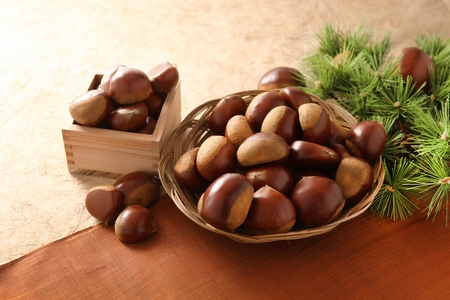 chestnuts stacked on plate and small wooden plateの写真素材