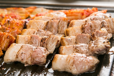 kimchi and pork belly on grillの写真素材