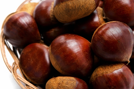 chestnuts stacked on plate, white backgroundの写真素材