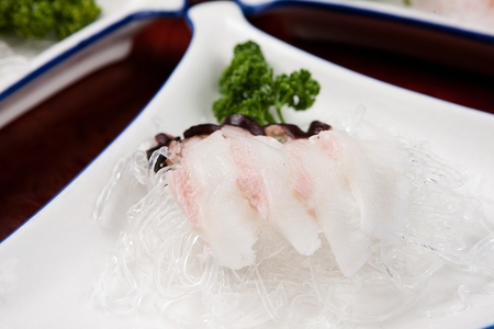 raw flatfish on plate, with steamed seaweed noodlesの写真素材