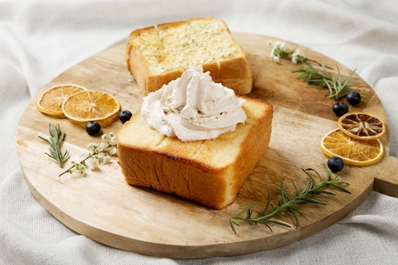 garlic bread and honey bread on wooden plateの写真素材