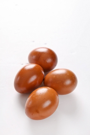 four stone-plate cooked eggs in white backgroundの写真素材