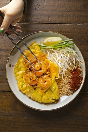 Yum Woon Sen, Thai glass noodle salad with bean sprouts and shrimps on chopsticksの写真素材