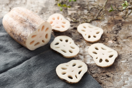 half a lotus root on rough surface and peeled lotus rootの写真素材