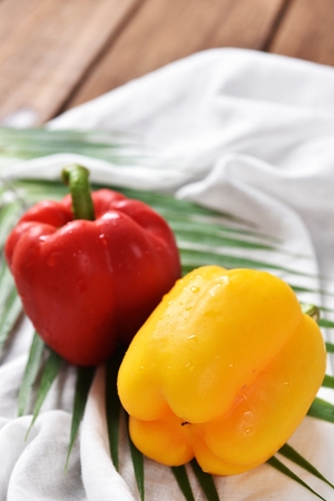 yellow paprika and red paprika on clothの写真素材