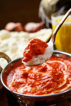 spoon scooping up rice with curry and cream sauceの写真素材