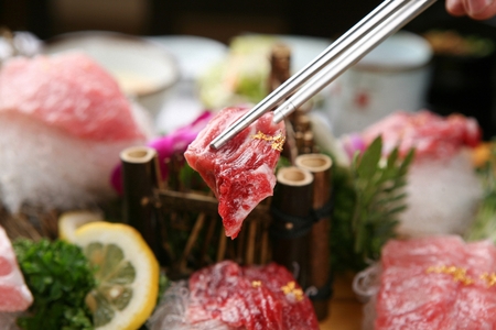 chopsticks grabbing raw tunaの写真素材