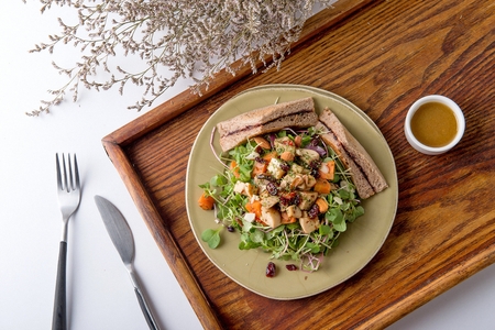 salad composed of carrots, nuts and sprouts, served with sandwichの写真素材