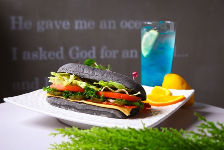 sandwich with various vegetables, served with blue lemonadeの写真素材