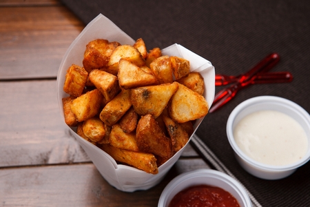 french fries in paper packing with two sauces