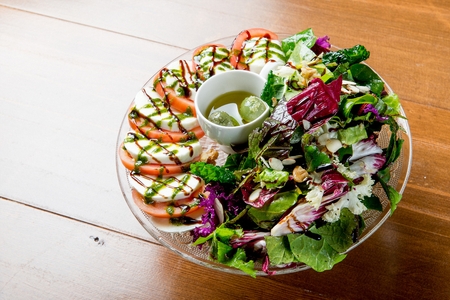 salad with nuts and sauce, with tomatoes and ricotta cheeseの写真素材
