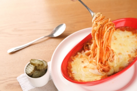 fork grabbing cheese oven pastaの写真素材