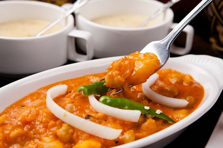 fork scooping up shrimp curryの写真素材