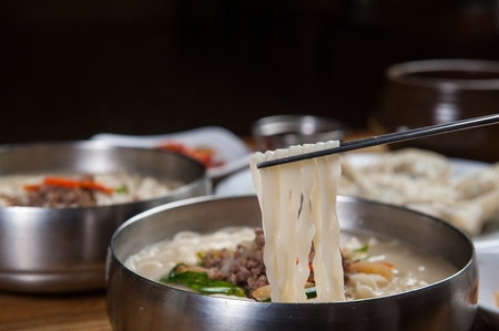 hot chopped noodles soup with various vegetables and meatの写真素材