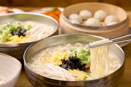 hot chopped noodles soup with various vegetables and meatの写真素材