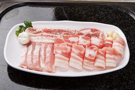 raw pork with parselyの写真素材