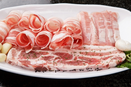 raw pork with parselyの写真素材