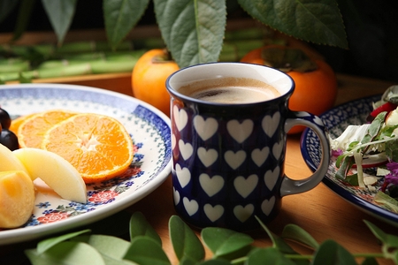 americano in cup, with salad and fruits on platesの写真素材