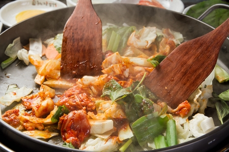 rice paddle stir-frying not yet cooked spicy stir-fried chicken and various vegetablesの写真素材