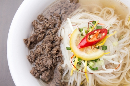 rice noodles soup with meat and onions