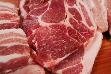 raw pork on chopping boardの写真素材