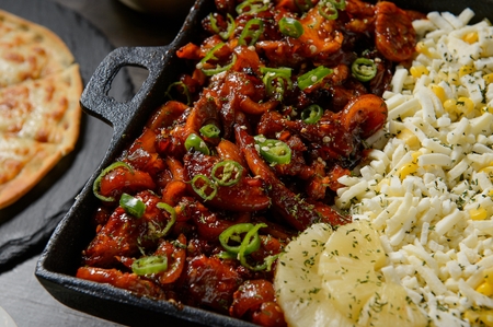 chopsticks grabbing spicy pigs' feet and cheese