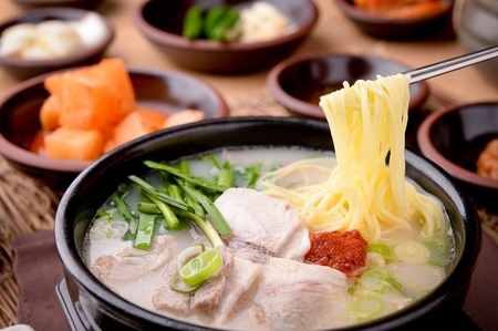 rice soup with chives, sauce, pork and noodlesの写真素材